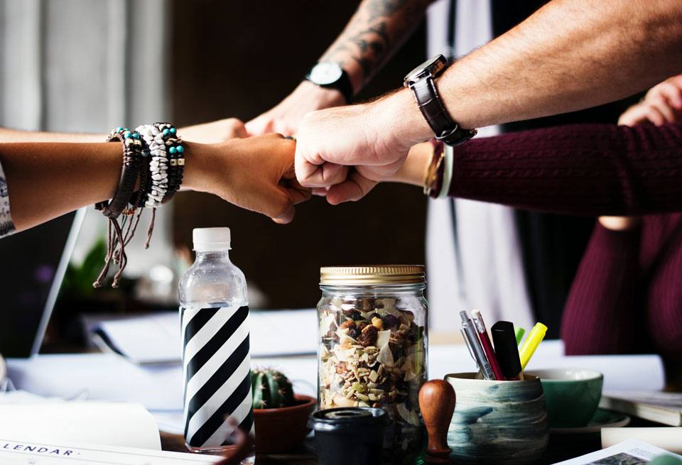 Teamwork makes the dreamwork: "everybody in" fists together in a circle photograph.