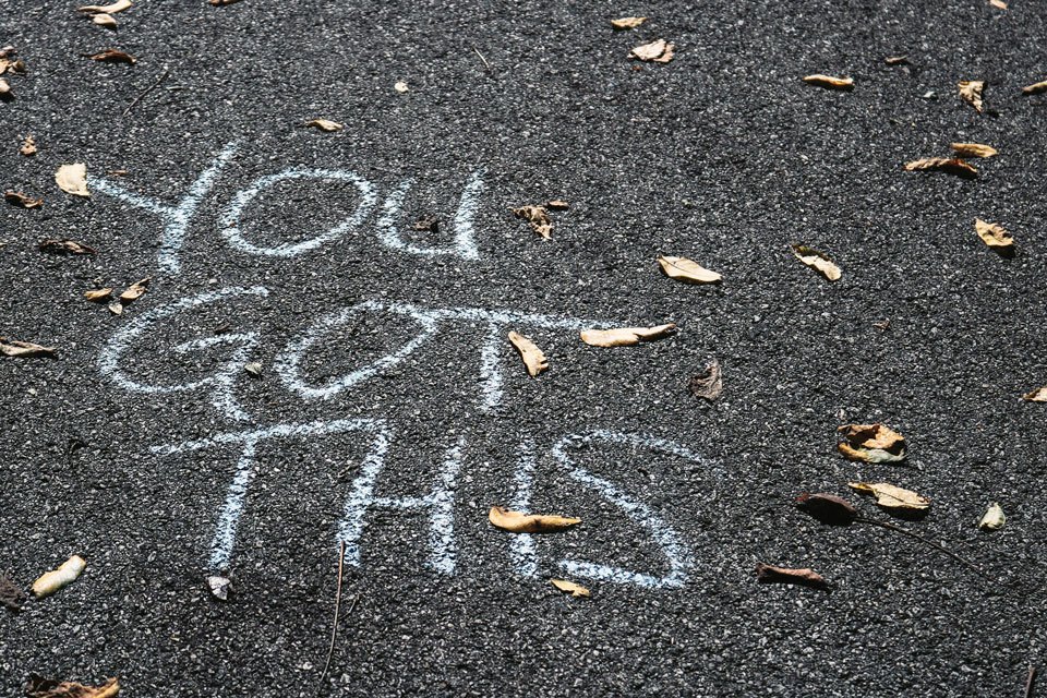 You got this. The road that lies ahead is paved, and ready for you to begin your adventure. Photograph of "You Got This" written in chalk on asphalt. 